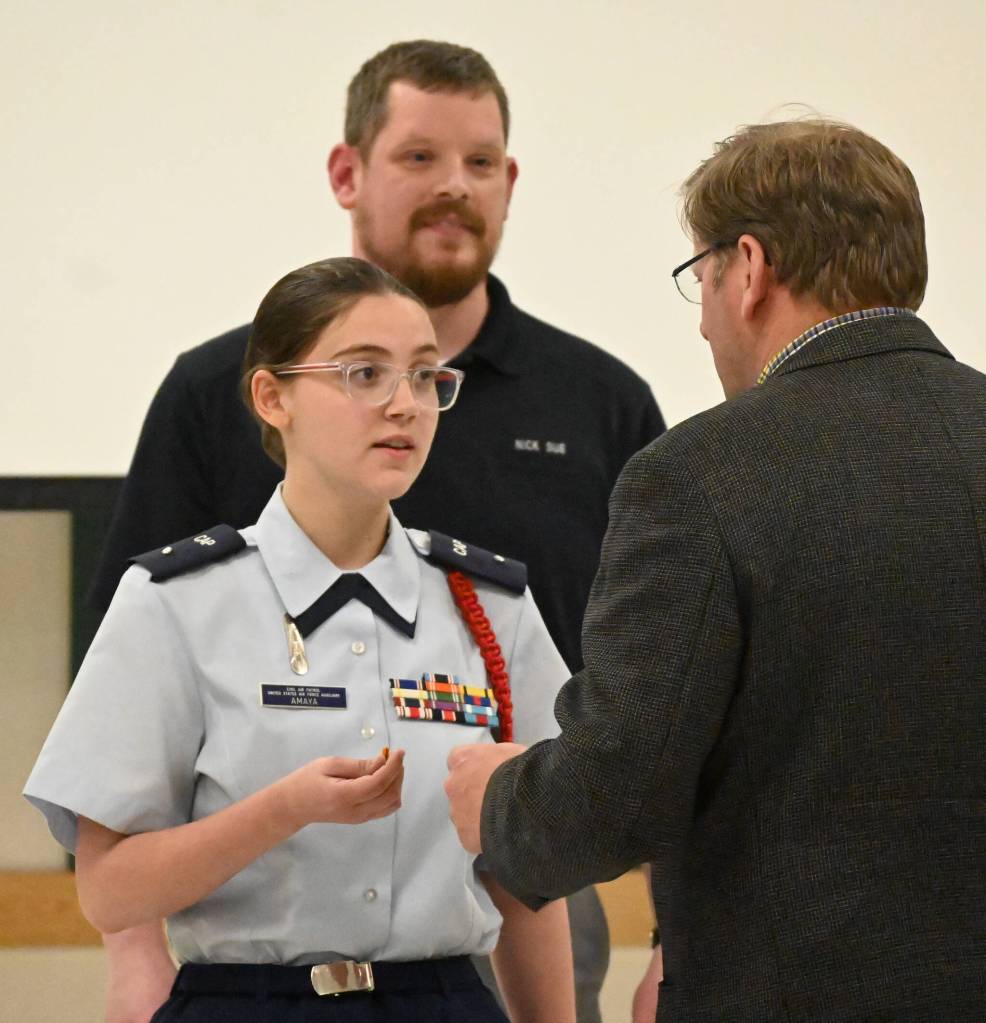 With Deputy Commander of Cadets Capt. Nick Sue looking on, Faith Amaya of Sequim is congratulated by State Rep. Mike Chapman, right, for Amayas promotion to Cadet Second Lieutenant on May 17. Sequim Gazette photo by Michael Dashiell