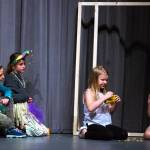 Tricksters played by Mia Buhrer and Matilda Woodbury watch the dragons played by Emma Abken and Bekah Abken eat specially prepared tacos. Sequim Gazette photo by Emily Matthiessen