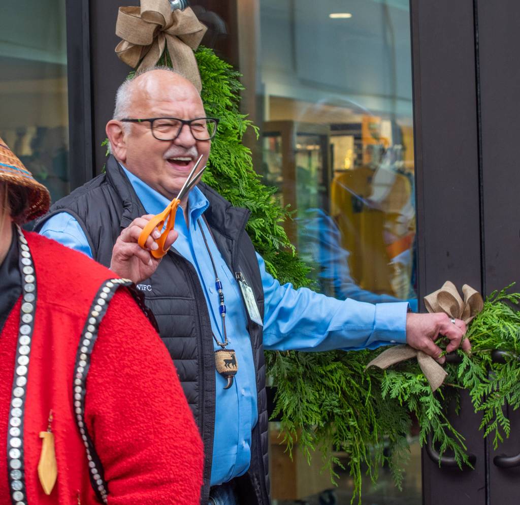 Sequim Gazette photo by Emily Matthiessen / W. Ron Allen, tribal chairman for the Jamestown SKlallam Tribe, cuts a wreath to celebrate the opening of the Dungeness River Nature Center on June 5.