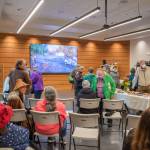 Sequim Gazette photoS by Emily Matthiessen
Above: Community members and dignitaries explore the newly-refurbished and expanded Dungeness River Nature Center Sunday afternoon. Upper left: Annette Hanson helps the community celebrate the opening of the center, which got its start four decades ago when her late husband started a museum at the old Sequim High School building on North Sequim Avenue for students. Lower left: W. Ron Allen, tribal chairman for the Jamestown SKlallam Tribe, cuts a wreath to celebrate the opening of the Nature Center.