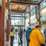 Sequim Gazette photoS by Emily Matthiessen
Above: Community members and dignitaries explore the newly-refurbished and expanded Dungeness River Nature Center Sunday afternoon. Upper left: Annette Hanson helps the community celebrate the opening of the center, which got its start four decades ago when her late husband started a museum at the old Sequim High School building on North Sequim Avenue for students. Lower left: W. Ron Allen, tribal chairman for the Jamestown SKlallam Tribe, cuts a wreath to celebrate the opening of the Nature Center.