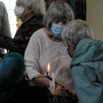 Sequim Gazette photo by Matthew Nash/ Pat Rublaitus helps light candles for a candlelight prayer service on May 27 inside St. Lukes Episcopal Church in Sequim for the victims of the Robb Elementary School shooting in Uvalde, Texas. About 40 people attended to pray and sing for the teachers and students and their families.