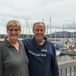 Susan Sorensen, an organizer and publicity chair for the Reach and Row for Hospice, and Mike Crim, one of the founders of the race, enjoy tales of the events origins at Sequim Bay Yacht Club in early June. Sequim Gazette photo by Michael Dashiell