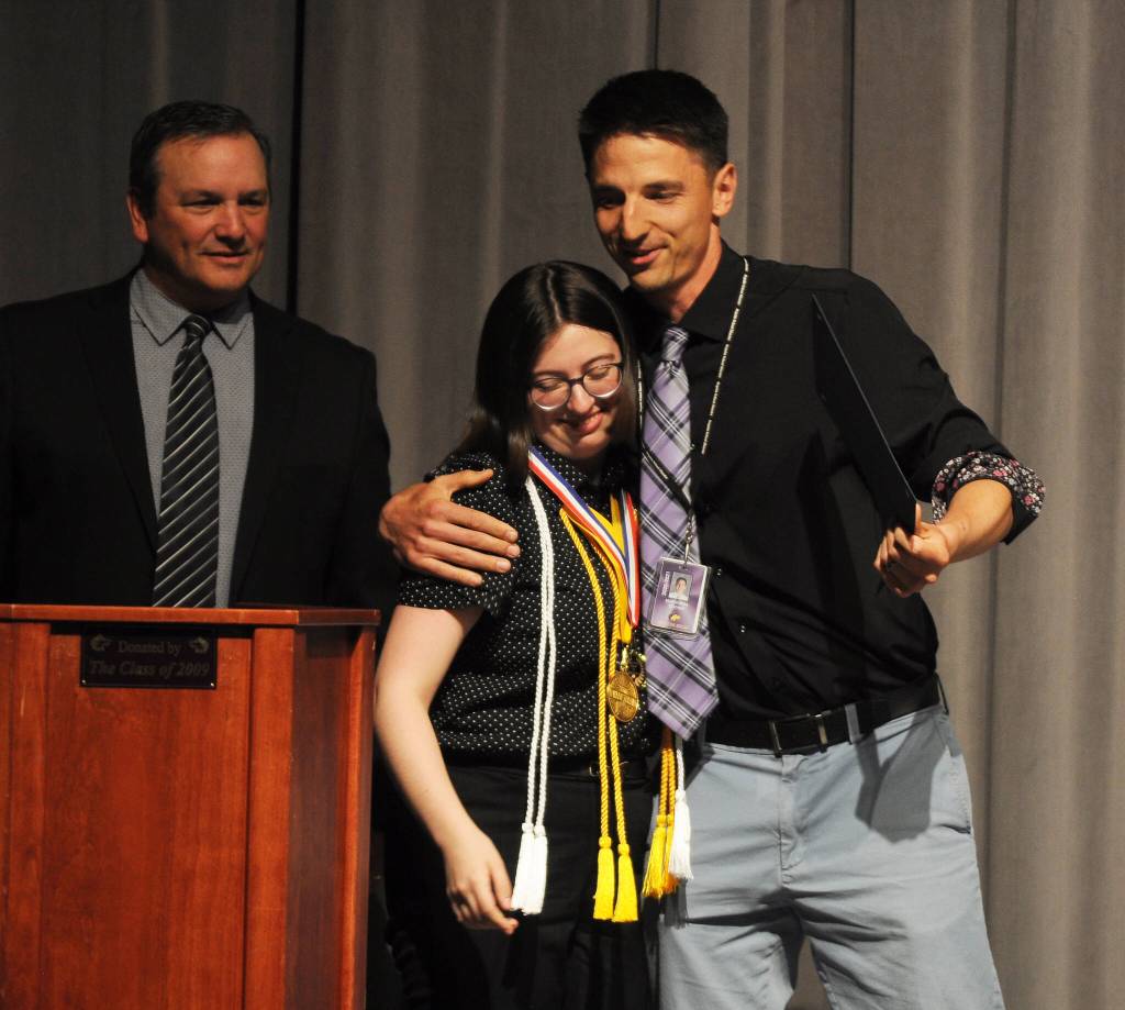 Sequim Gazette photo by Michael Dashiell
Sequim High School teacher Sean OMera, right, and SHS principal Shawn Langston congratulate Madelyn Pickens for earning the schools Heart of Purple and Gold award at the SHS scholarship awards ceremony on June 1.