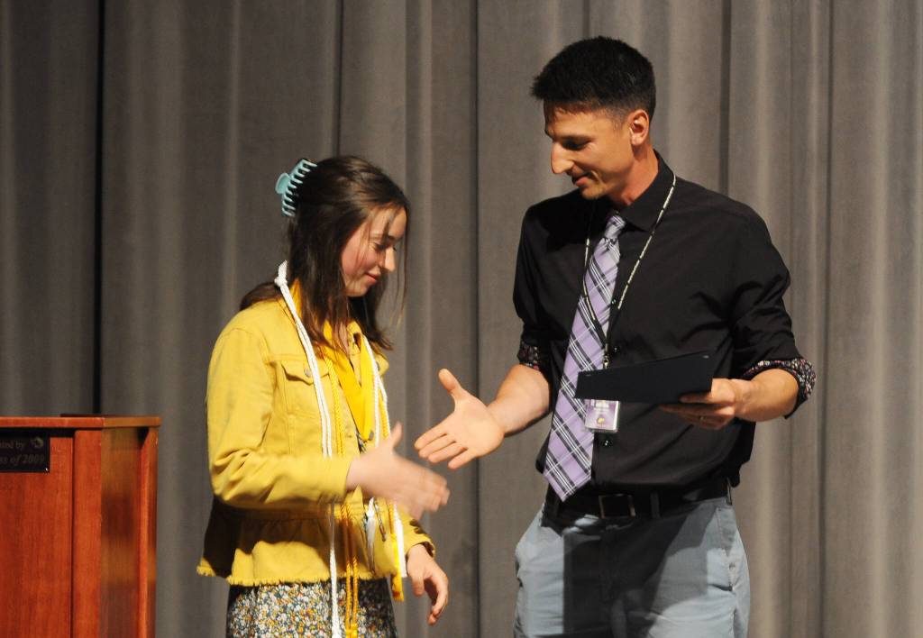 Sequim High School teacher Sean OMera congratulates Rileigh Van Dyken for her selection as the schools Outstanding Senior of the Year, honoring her efforts in academics, athletics and leadership. equim Gazette photo by Michael Dashiell
