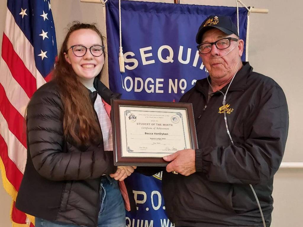 Submitted photo
Sequim High School student Becca Van Dyken, Sequim Elks Student of the Month for April 2022, accepts her award from District Deputy/Sequim Elk Trustee Charlie Johnson at a recent Elks meeting.