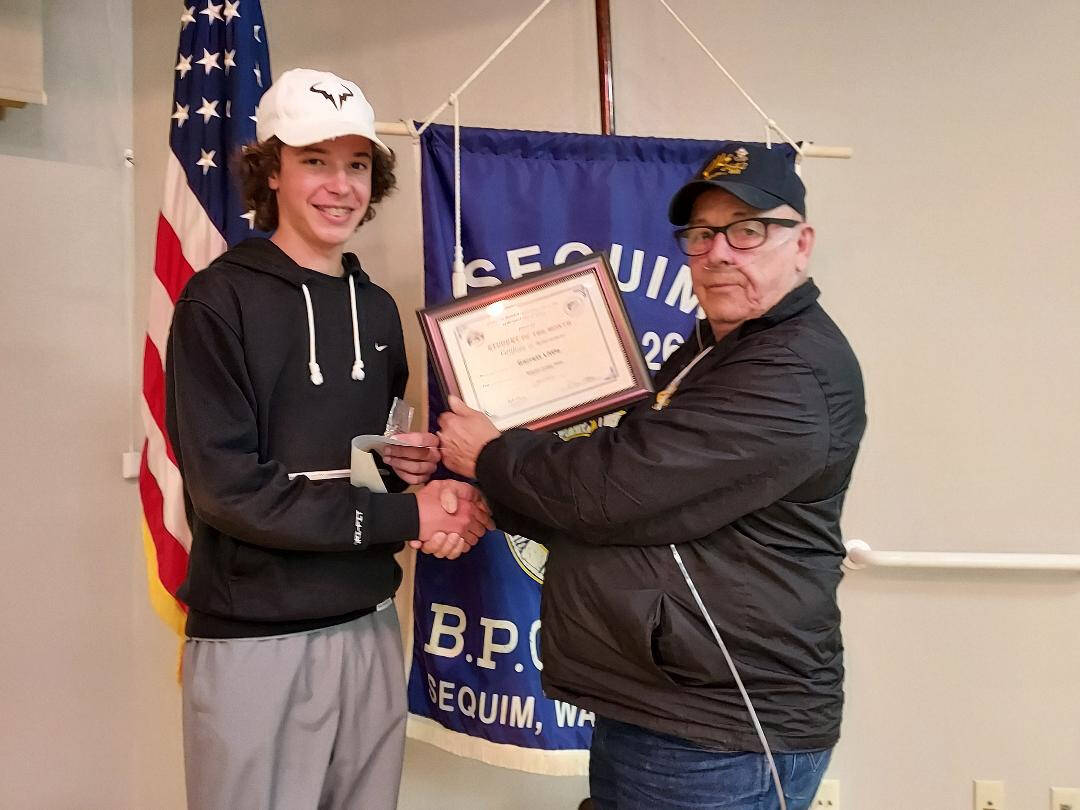Submitted photo
Sequim High School sophomore Garrett Little accepts his Sequim Elks Student of the Month for May 2022 from District Deputy/Sequim Elk Trustee Charlie Johnson.
