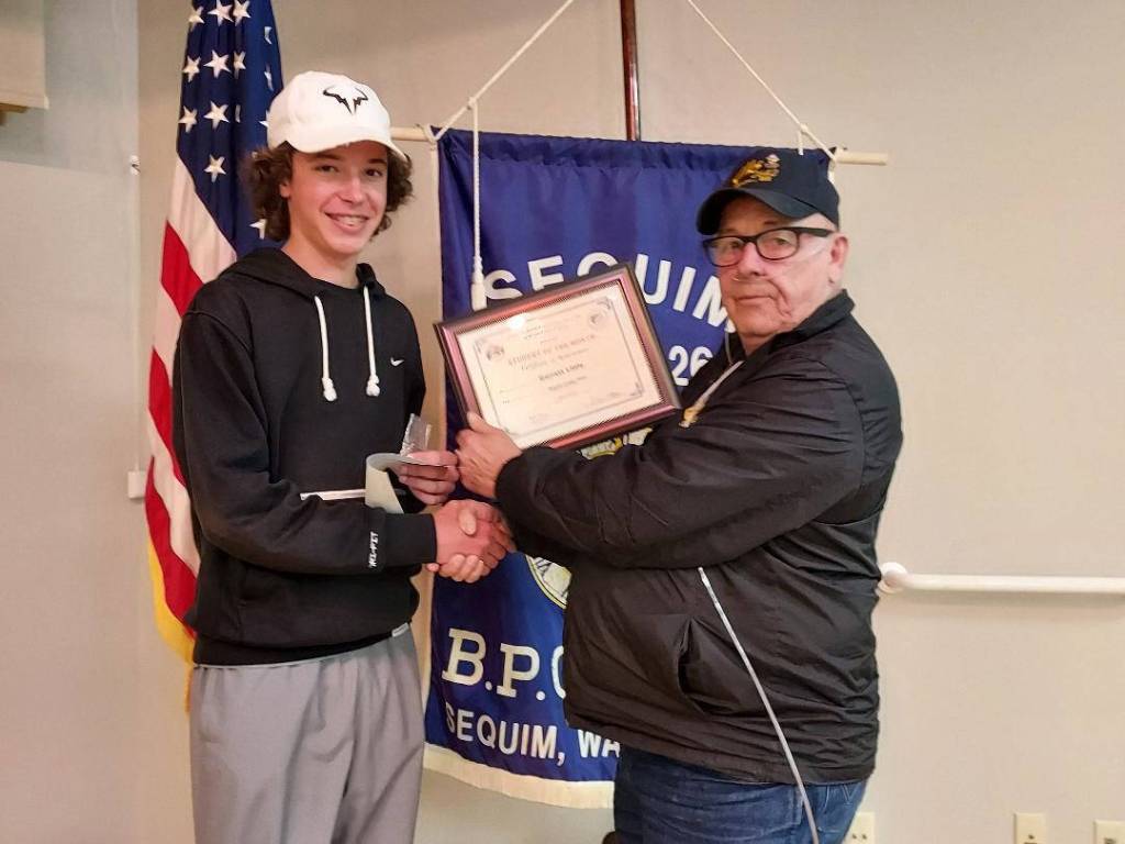 Submitted photo
Sequim High School sophomore Garrett Little accepts his Sequim Elks Student of the Month for May 2022 from District Deputy/Sequim Elk Trustee Charlie Johnson.