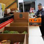Sequim Gazette photo by Matthew Nash
Melody Wilson, produce manager for the Sequim Food Bank, helps ready boxes for distribution last week. The facility doubled its contract with five area farms for produce this year to promote healthier eating and promote local agriculture.