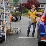 Sequim Gazette photo by Matthew Nash
Patti Winnop-Colwell, a long-time Sequim Food Bank volunteer, helps a visitor pick out some items from the facilitys drive-through on June 3.