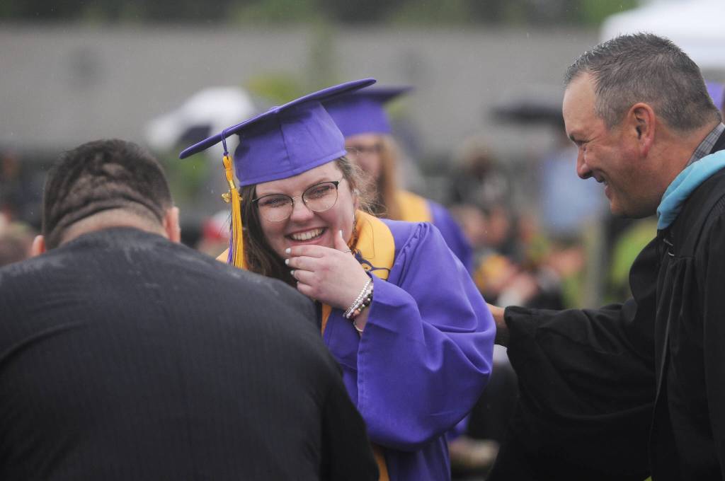 Sequim High School graduating senior Abigail Carlson shares a lighthearted moment with SHS principal Shawn Langston, right, at SHSs Class of 2022 graduation.