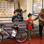 Helen Haller Elementary principal Kristi Queen present bikes to Jaxon Strait and Isaac Malkasian for their reading growth. Bikes were donated by Sequim Masonic Lodge. Submitted photo