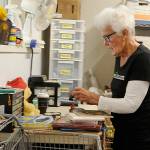 Sequim Gazette photo by Matthew Nash
Rita Thatcher, a volunteer at Serenity Thrift Store in Sequim, sorts books and movies to sell in the shop.