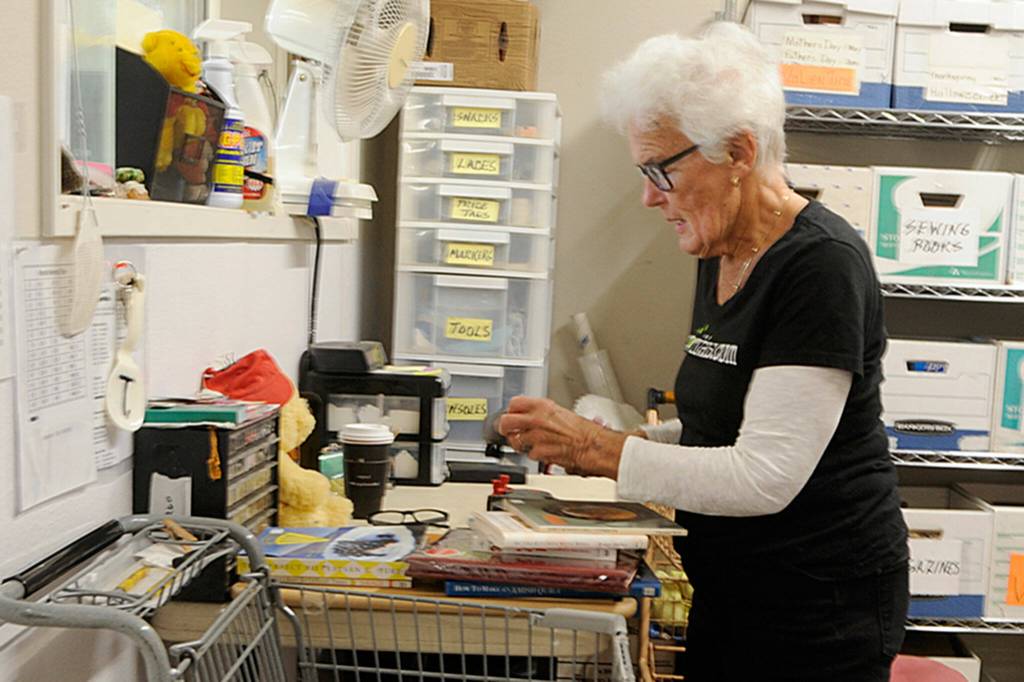 Sequim Gazette photo by Matthew Nash
Rita Thatcher, a volunteer at Serenity Thrift Store in Sequim, sorts books and movies to sell in the shop.