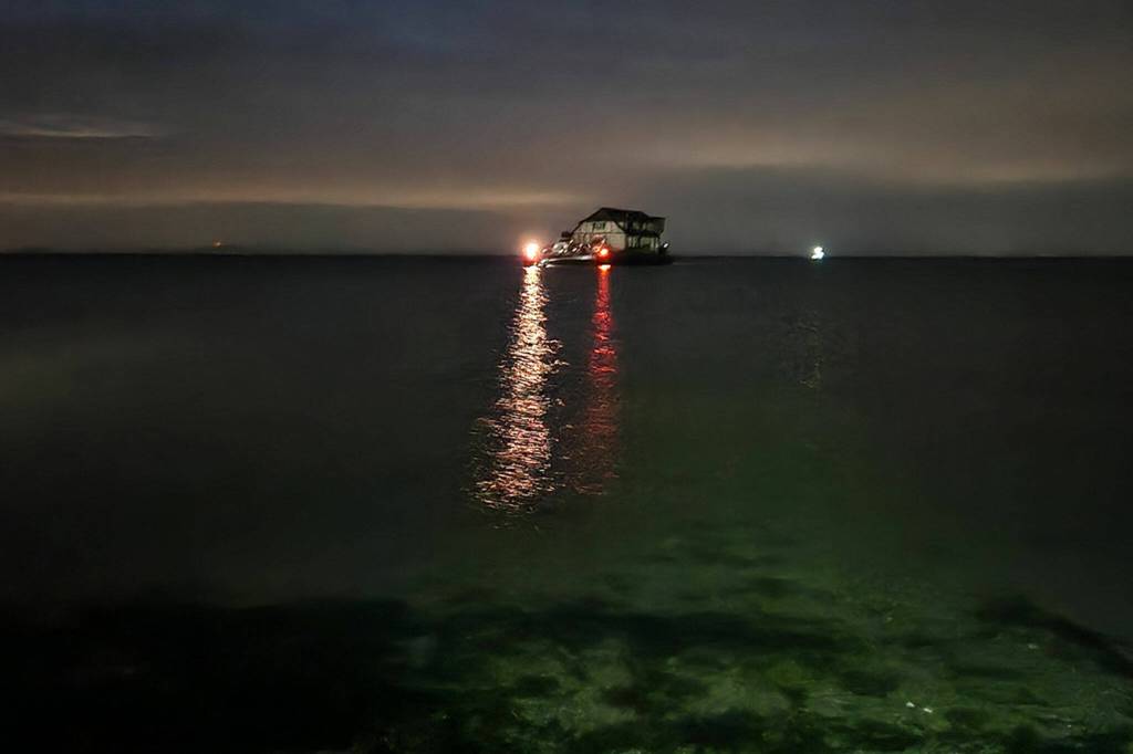 Photo courtesy Brian Pace/ A home purchased by Martha Vaughan awaits high tide to come in for delivery in Dungeness on June 8.