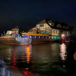 Photo courtesy Jeff McCord, Nickel Bros
A crowd gathers late on June 8 to watch Martha Vaughans new home be delivered by Nickel Bros crew members to its new home on 3 Crabs Road.