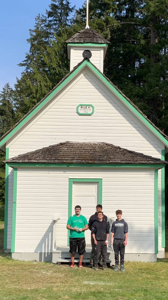 Submitted photo
Andy Benitez (back row, center) and fellow Scouts BSA members and friends complete a repainting of the Blue Mountain School earlier this year. Pictured with Benitez are (back row, from left) Beau Halverson, Hunter Halverson (front) and Kayden Disinski (right).