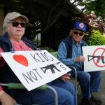 Sequim Gazette photo by Matthew Nash
Jan and Eldon Dennis of Sequim sat on June 11 along Washington Street for the 2022 March for Our Lives with signs theyve kept since the 2018 shooting at Marjory Stoneman Douglas High School in Parkland, Fla. Were not anti-gun. We want to let our community know how we feel, especially about assault guns. We would like them banned, said Jan, a retired nurse from Juneau, Alaska. Were anti-easy accessibility, said Eldon, a retired chemistry and physics teacher.