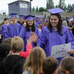 Sequim Gazette photo by Matthew Nash/ Sequim High senior Alisa Bibaj gives a high five during the Grad Walk on June 10.