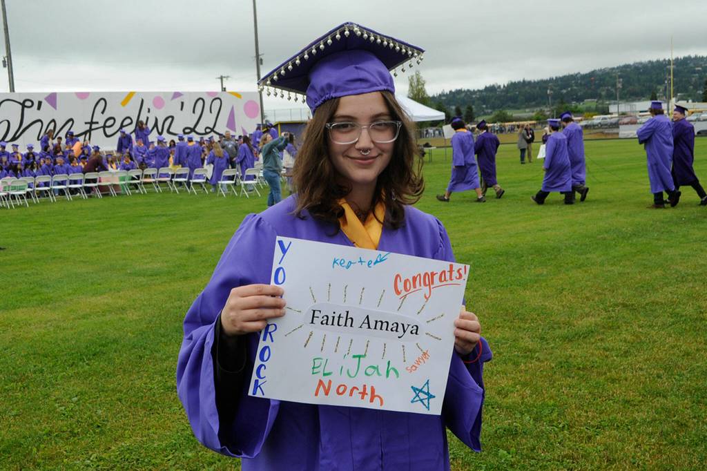 Sequim Gazette photo by Matthew Nash/ Faith Amaya holds her sign up after walking in the Grad Walk with fellow seniors. Faith is set to receive an Associate of Arts degree through the Running Start program.