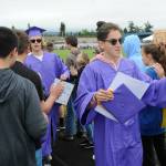 Sequim Gazette photo by Matthew Nash/ Sequim High seniors Harrison Bell, left, and Rafael Flores give high fives as they go through the 2022 Grad Walk.