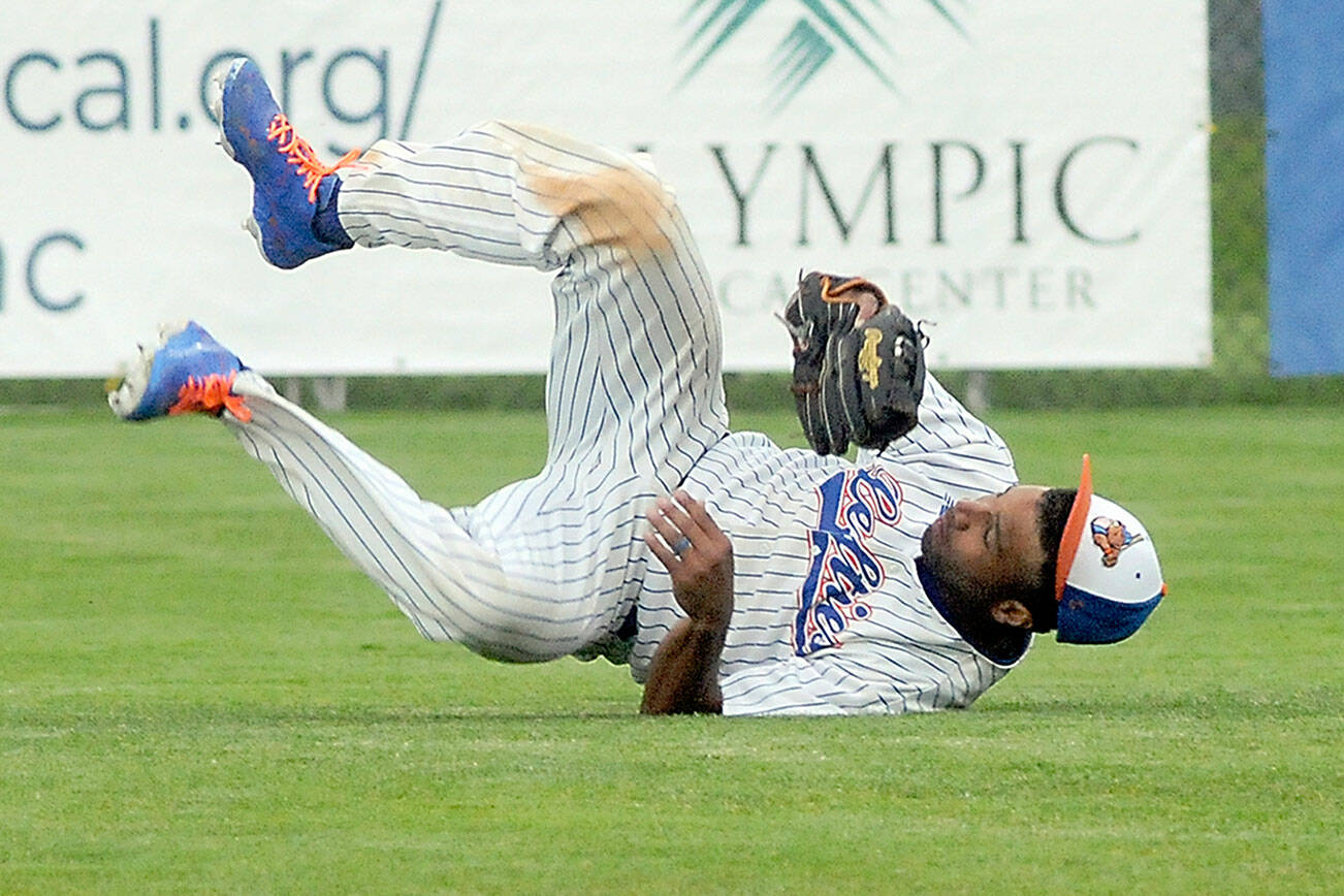 Keith Thorpe/Peninsula Daily News
Lefties' center fielder Golden Tate rolls on the ground after making a diving catch in the top of the third to end Bend's half of the inning on Tuesday in Port Angeles.