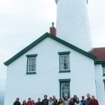 Photo by John Lato III 
Race 2 Alaska participants who were stranded at the lighthouse join lighthouse keepers and race event staffers at the Dungeness Lighthouse on June 14.