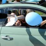 Sequim Gazette photo by Matthew Nash/ Eighth grader Laila Sundin leans to receive a certificate for finishing the school year at the Sequim Middle School drive-through event on June 16.