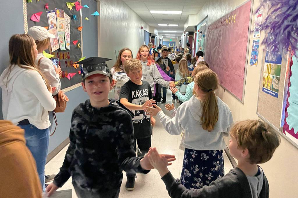 Sequim Gazette photo by Matthew Nash/ Fifth graders from Aaron Renos class at Greywolf Elementary Alice Hodge, Silas Harrington, Jordan Rogers, Alexa Fuller and many more walk the halls as schoolmates from other grades cheer for them on June 16.