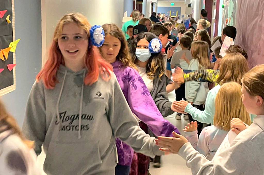 Sequim Gazette photo by Matthew Nash/ Fifth graders from Aaron Renos class at Greywolf Elementary Elias Shinkle, Corbin Strawn, Brooklyn Sorensen, Mylie Johnson and many more walk the halls as schoolmates from other grades cheer for them on June 16.