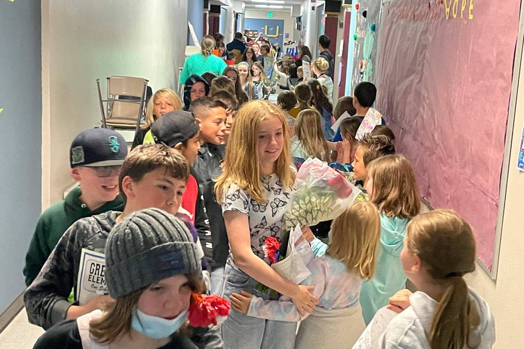 Sequim Gazette photo by Matthew Nash/ Fifth graders at Greywolf Elementary Mylie Johnson, Payden Geller, and Alexandra Gonzalaz-Adams walk the halls as schoolmates give high fives and fist bumps on June 16.
