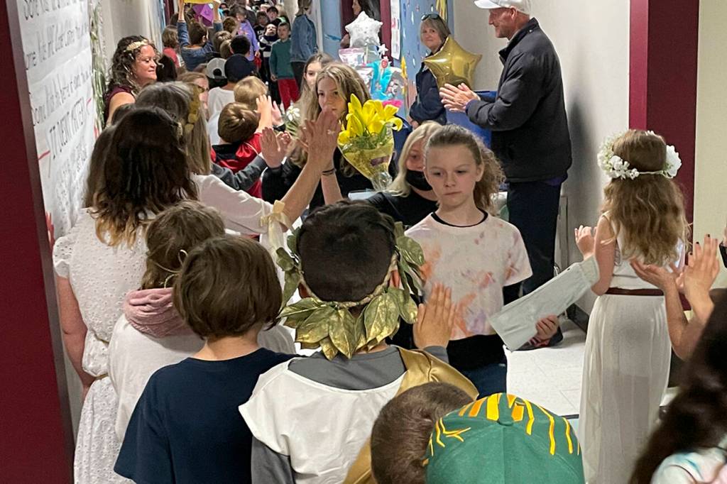 Sequim Gazette photo by Matthew Nash/ Jocelin Hough, Kloe DeMeyer and other Greywolf Elementary fifth graders walk the halls as schoolmates from other grades cheer for them on June 16 as they move onto middle school next fall.