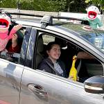 Sequim Gazette photos by Matthew Nash
Sequim Middle School student Emma Gilliam smiles as puppets  held by her parents Glenn and Kecia  cheer for her during the drive-through event celebrating eighth graders moving onto high school.