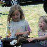 Sequim Gazette photo by Matthew Nash
Edith, 5, and Louisa Gilles, 3, speak with Olympic National Park ranger Coady Johnson on June 23 during the kickoff of the Sequim Librarys Summer Reading Program. Events take place all summer along with chances for readers to win prizes and earn T-shirts.