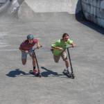 Preston Kurtz and Gunnar Peterson compete in a scooter race during the fundraiser for Carrie Blake Skatepark on Saturday. Sequim Gazette photo by Emily Matthiessen