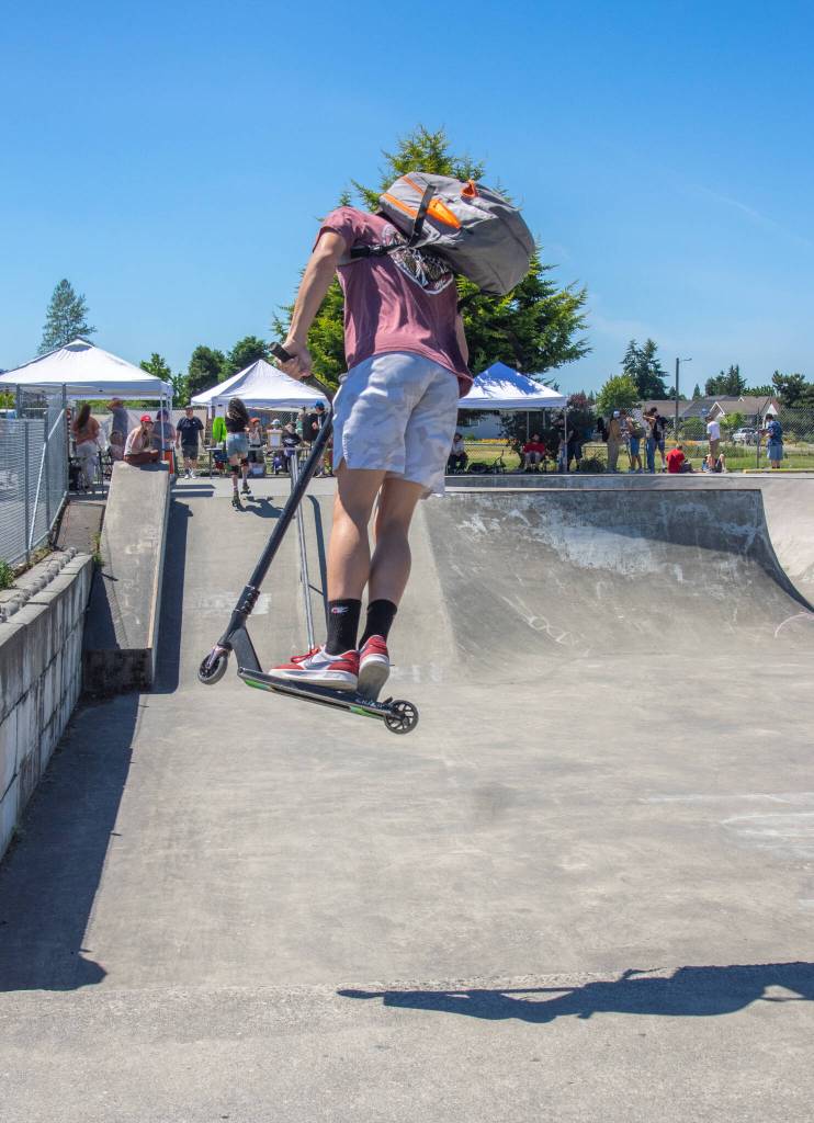 Preston Kurtz does a trick with his scooter on a quarter pipe at Carrie Blake skatepark on Saturdayd during the Sequim Youth Skatepark Foundations fundraiser. Sequim Gazette photo by Emily Matthiessen