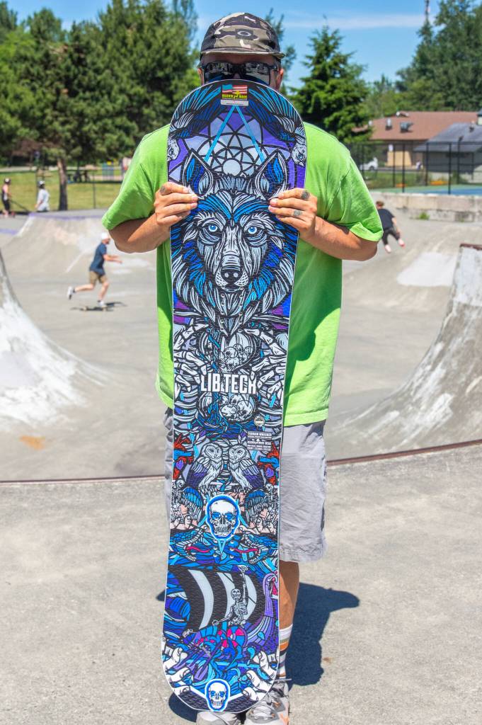 Sequim Gazette photo by Emily Matthiessen
Brian Eggiman holds the Lib Tech snowboard he won as grand prize in a raffle fundraising for repairs and expansion of Sequims Carrie Blake Skatepark on Saturday. Eggiman said he paid $10 for a beautiful snowboard worth $600. I feel so lucky, he said. I thought I didnt have a chance.
