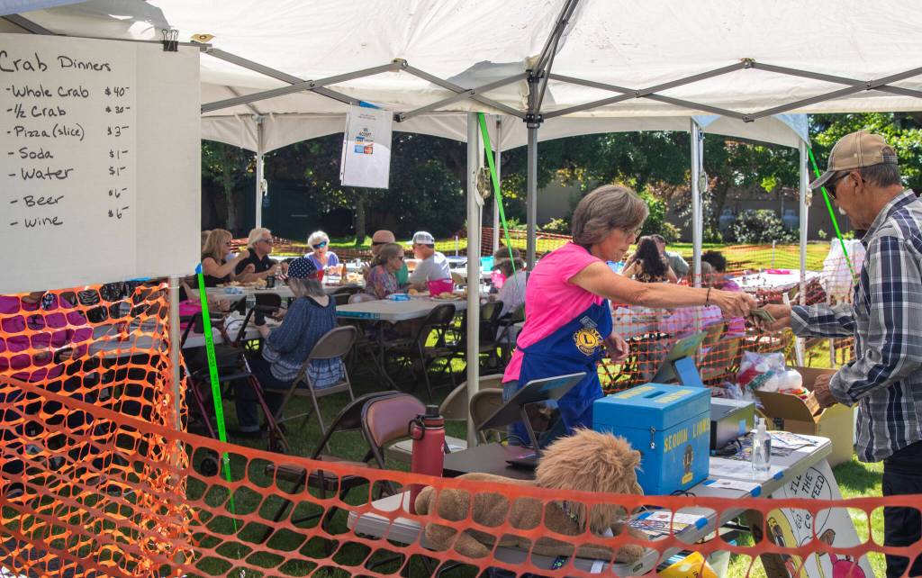"It's going really well," says Kim Romberg, volunteering at the Sequim Valley Lions 10th annual Crab Feed fundraiser on Saturday. "We're having a good turnout. The weather helped." Sequim Gazette photo by Emily MatthiessenSequim Gazette photo by Emily Matthiessen
