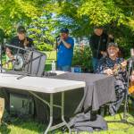 The Old Sidekicks play a lively set of songs for the crowd at the 10th annual Sequim Valley Lions Crab Feed in Pioneer Memorial Park on Saturday. Verne Sprague plays banjo, Steve Sahnow, harmonica, Jack Reagan, bass, Bill Camuso, mandolin and Don Betts, guitar. Sequim Gazette photo by Emily Matthiessen
