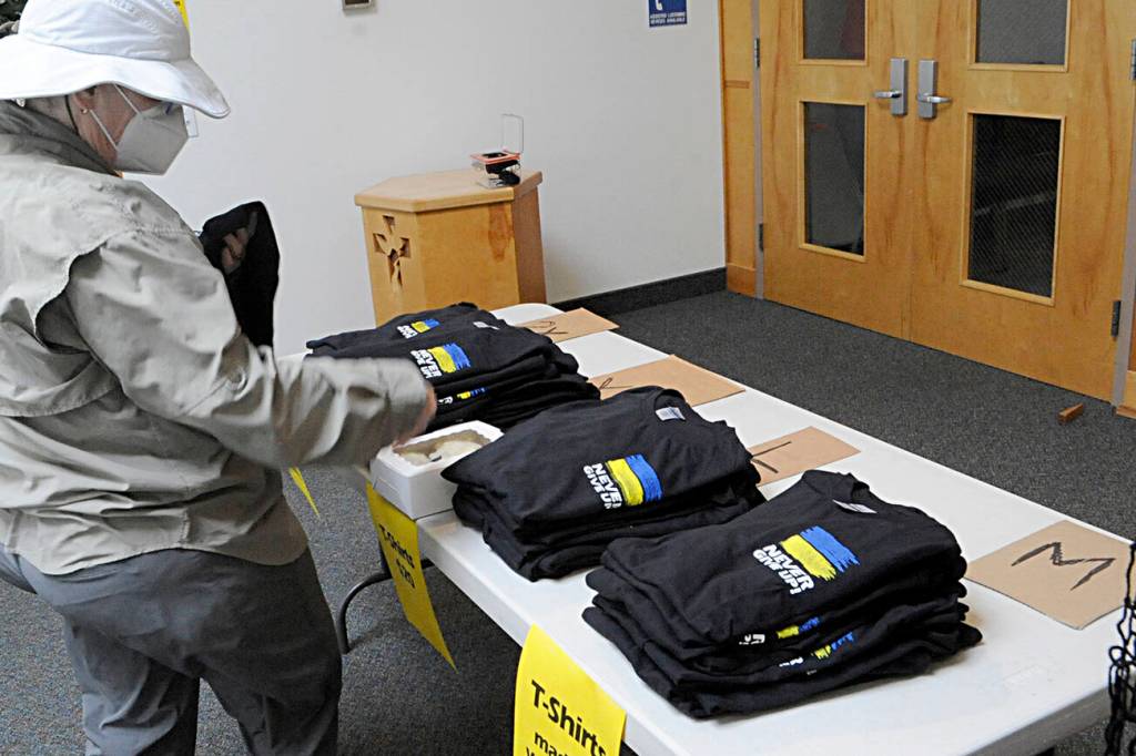 Sequim Gazette photo by Matthew Nash
T-shirts featuring the Ukraine flags colors and slogan Never give up made by Lorelee Wade and Jennifer Schroeder at Dungeness Valley Lutheran Church went on sale on June 28 for $20. Theyll remain on sale at the church 8 a.m.-4 p.m. through Aug. 9 to help Ukrainian refugees living in Washington state.