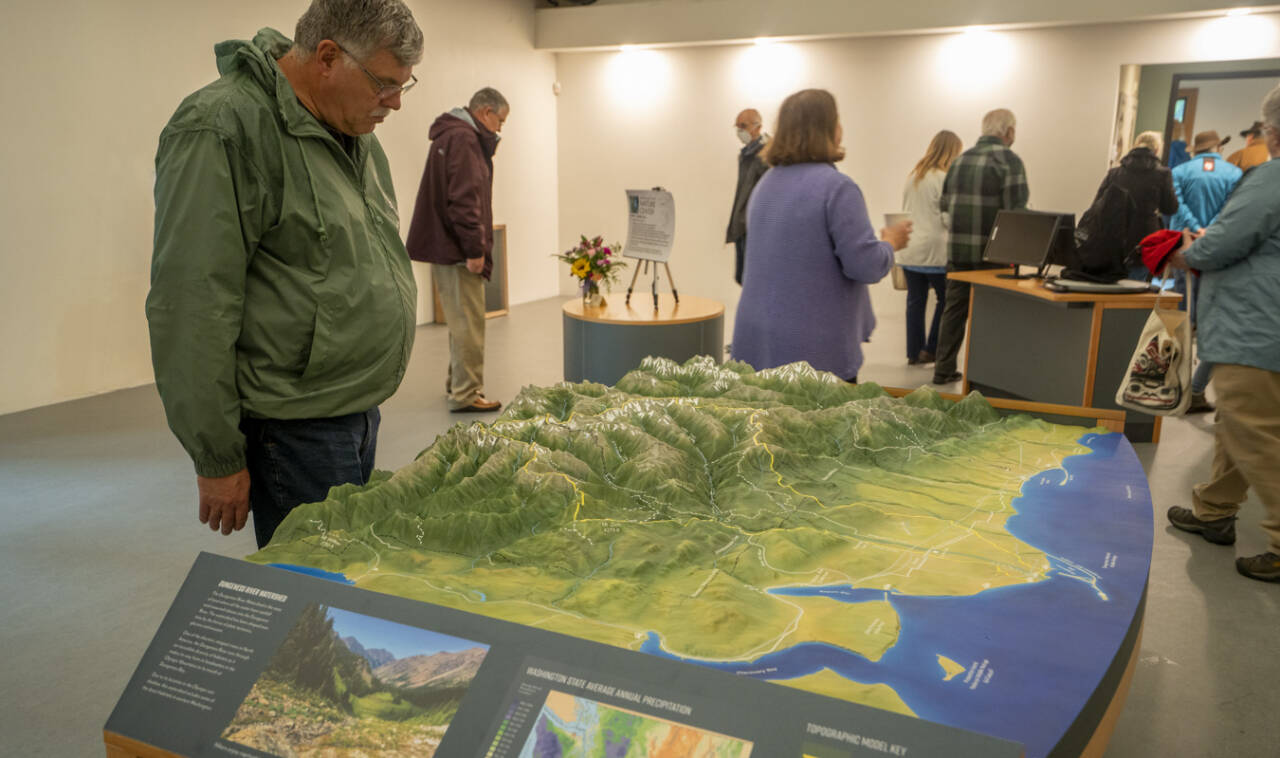 Photo by John Gussman/Jamestown SKlallam Tribe
Visitors get a look at the Dungeness River Nature Centers 3-D Dungeness River watershed table relief map. The center hosts open houses on July 6 and 7.