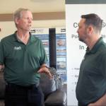 Photo by Keith Thorpe/Olympic Peninsula News Group / Dash Air Shuttle pilot Joshua Crabtree, left, speaks with airline president Clint Ostler on June 28 at William R. Fairchild International Airport.