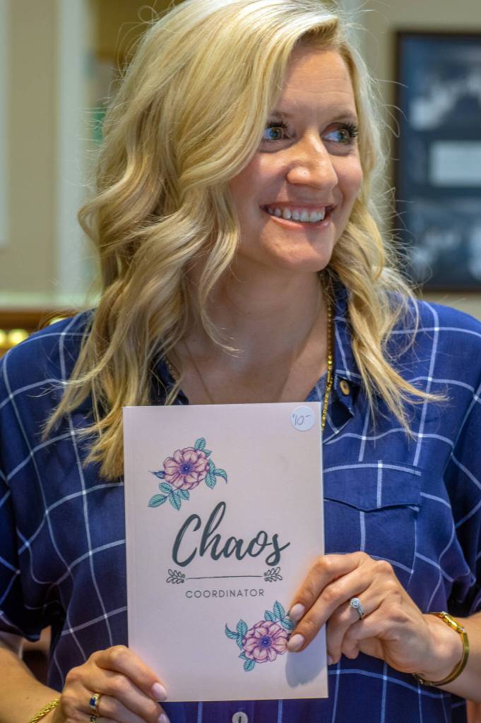 Libby Rogers holds an organizer she designed which is for sale at Coles Jewelry. Rogers is a graphic designer as well as businesswoman, and her touch can be seen in the sign and around the store.