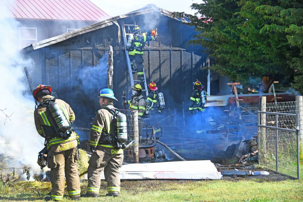 Photo by Jay Cline/Fire District 2 / Firefighters work to help put out a fire at an Agnew property on June 30.