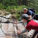 Submitted photo
Danielle Patterson, a Dungeness Composite Squadron senior member, and Captain Nick Sue examine the weathering on different pieces of the Tull Canyon B-17 crash aircraft.