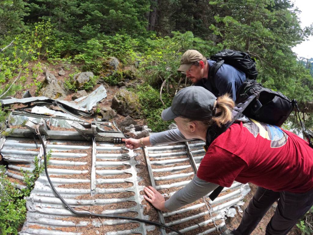 Submitted photo
Danielle Patterson, a Dungeness Composite Squadron senior member, and Captain Nick Sue examine the weathering on different pieces of the Tull Canyon B-17 crash aircraft.