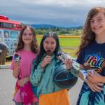 Sisters Katie and Megan Simpler and their friend Audrey Cabbage, center, enjoy ice creams on a very hot day bought from the NW Treats truck Sequim Gazette photo by Emily Matthiessen