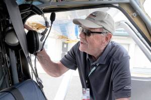 DART volunteer pilot Ray Ballantyne of Sequim prepares his airplane for a training airlift to Diamond Point Airport from Port Angeles on Saturday. (Keith Thorpe/Peninsula Daily News)