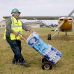 Photo by Keith Thorpe/Olympic Peninsula News Group
Kevin Deselms transports cases of bottled water after it was airlifted from Port Angeles during a DART training exercise on July 9 at Diamond Point Airport.