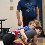 Sequim Gazette photo by Michael Dashiell / Former collegiate, national and world wrestling champion Gene Mills, left, works with campers at a summer camp in Sequim last week.